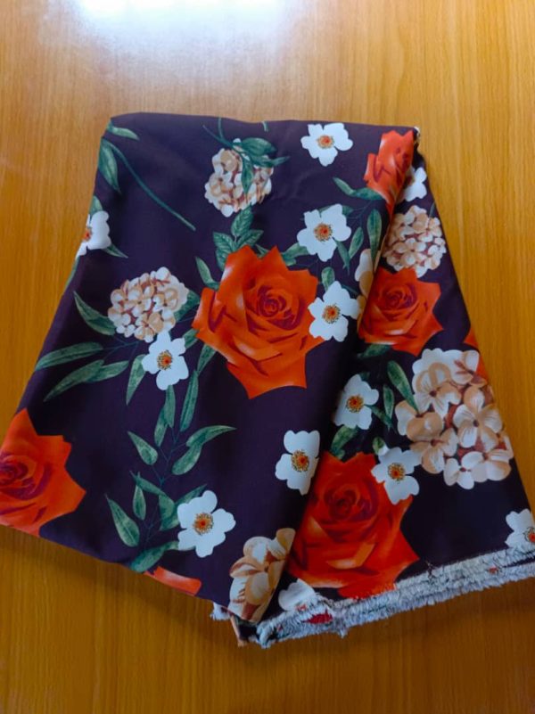 Premium deep plum silk fabric with bold burnt orange roses and delicate white floral prints. Perfect for elegant dresses, abayas, and modest outfits.